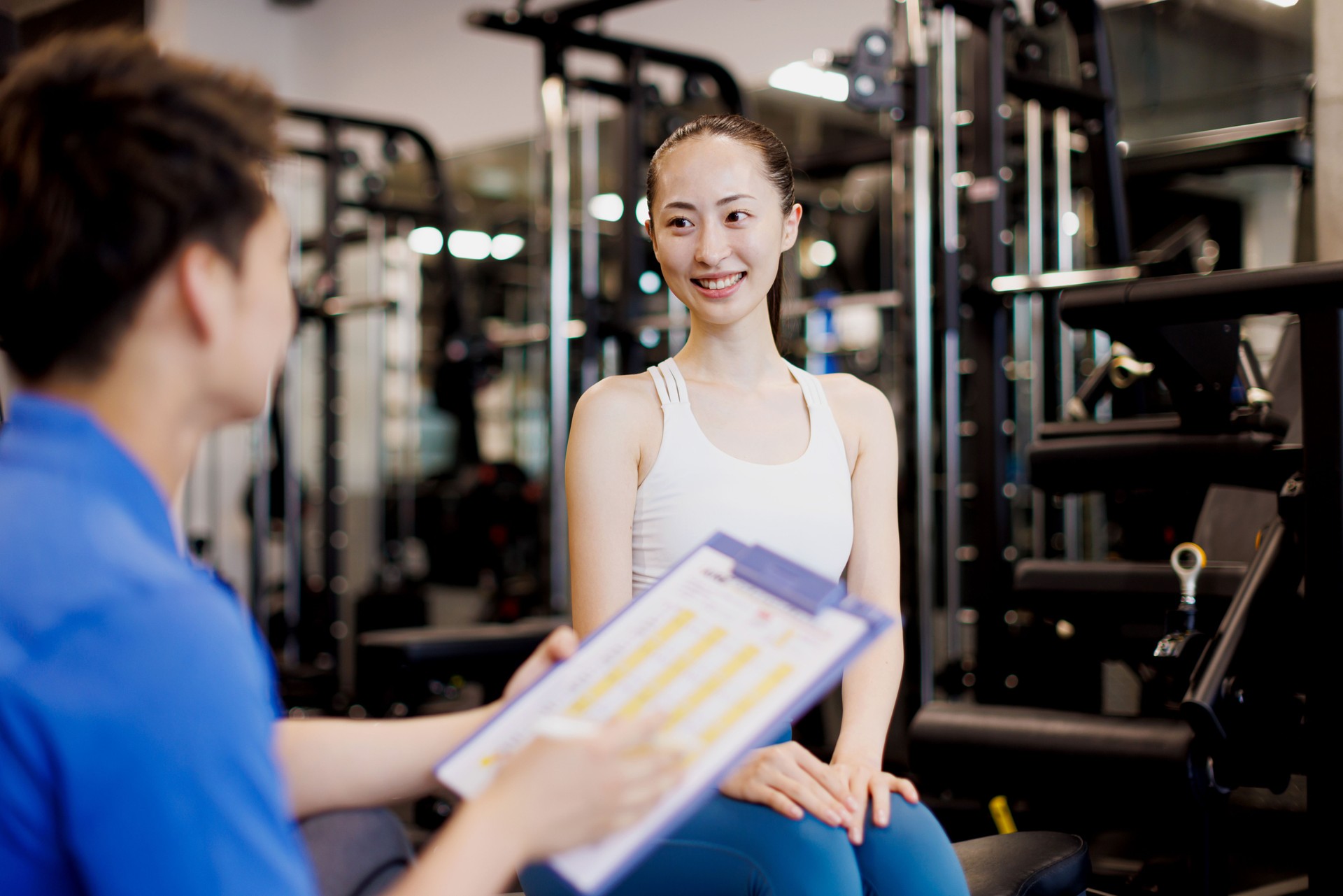 Personal trainer discussing with client at gym